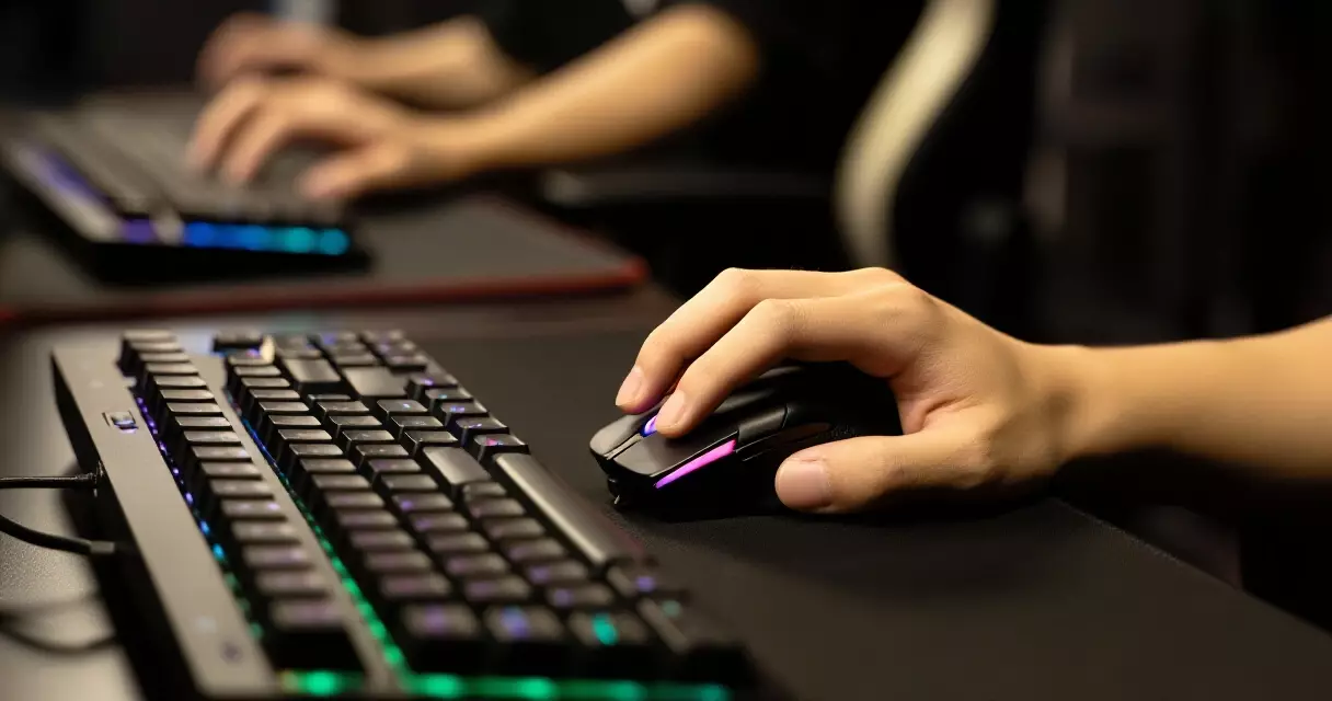 Esports player's hands on gaming keyboard and mouse during competition