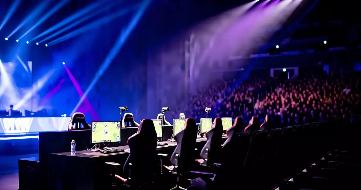 Empty esports tournament stage with gaming setups and dramatic arena lighting