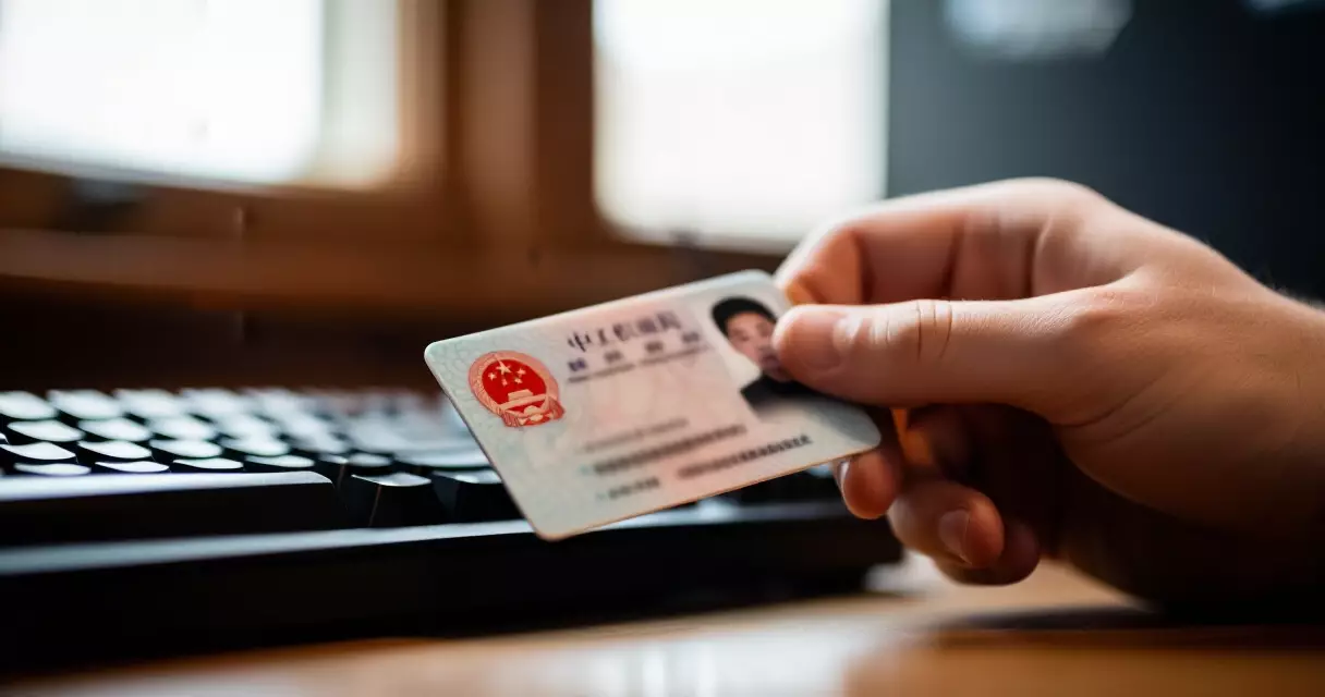 Player holding an ID card next to a gaming keyboard during esports tournament check-in