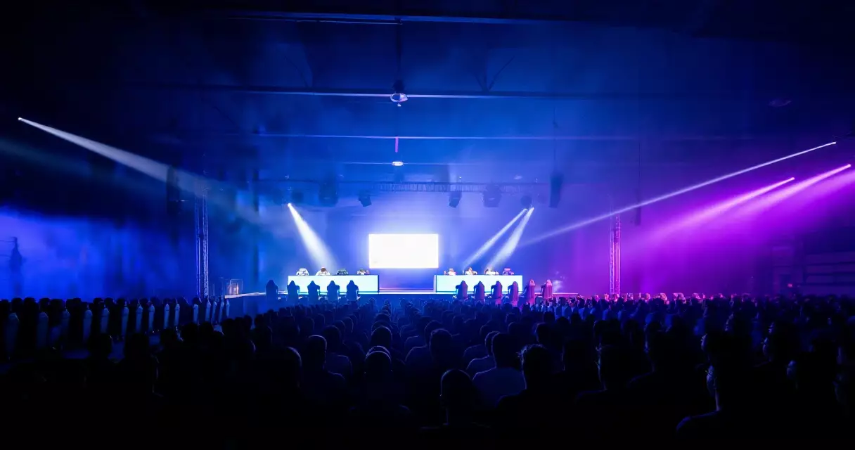 Esports tournament arena crowd watching live Dota 2 championship event