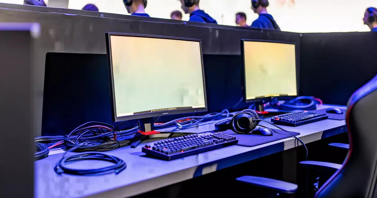 Sound-isolated esports player booth with gaming monitors and peripherals at a competitive event