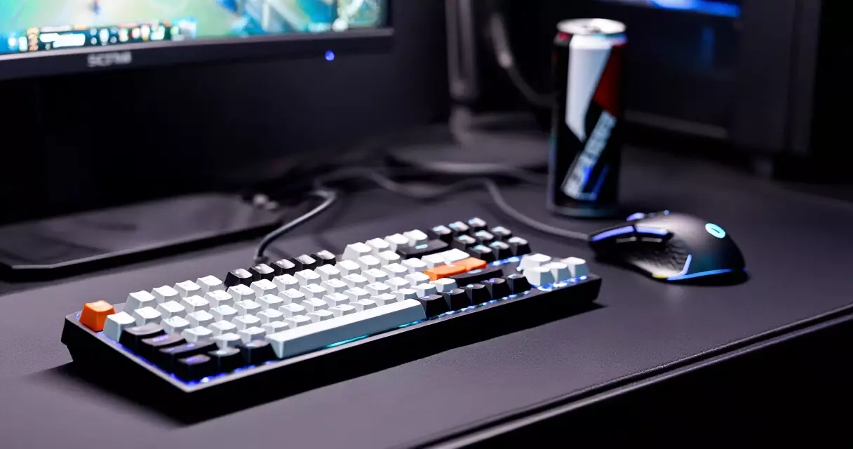 Professional gaming desk setup with keyboard, mouse, and an energy drink can