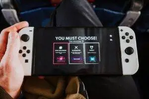 Close-up of a person holding a gaming console with an on-screen decision prompt.