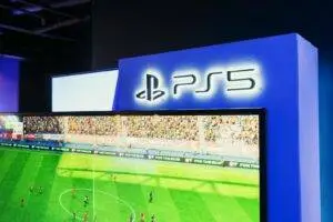 PS5 gaming station featuring a live soccer match onscreen, showcasing high-quality graphics.