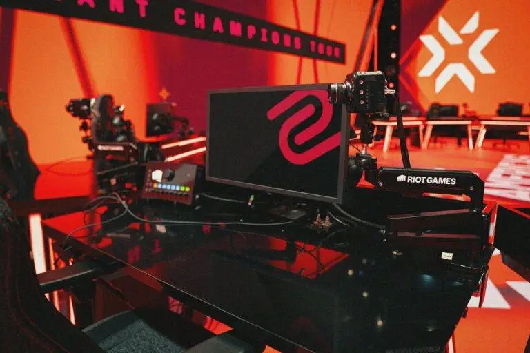 Valorant champions tour gaming station with a red background.
